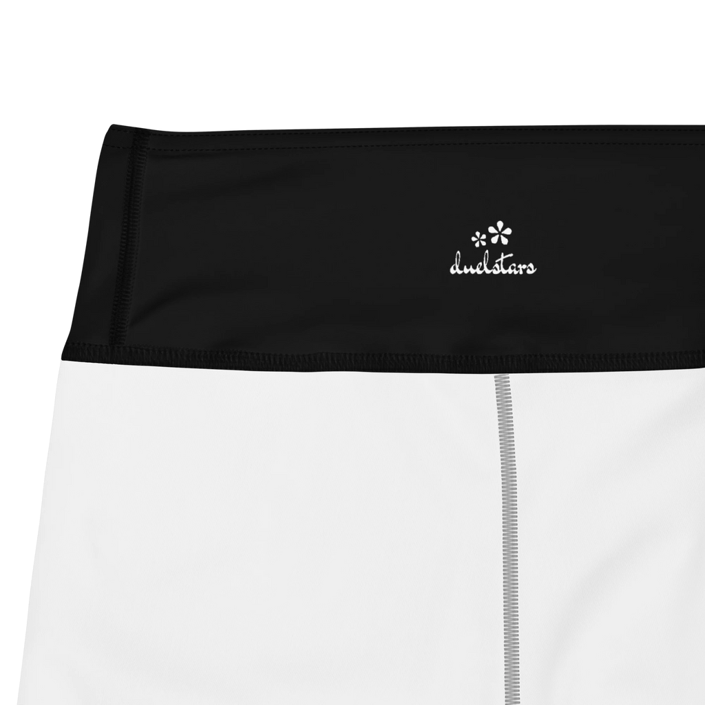 Close-up of the DuelStars label on black yoga shorts with white floral print 