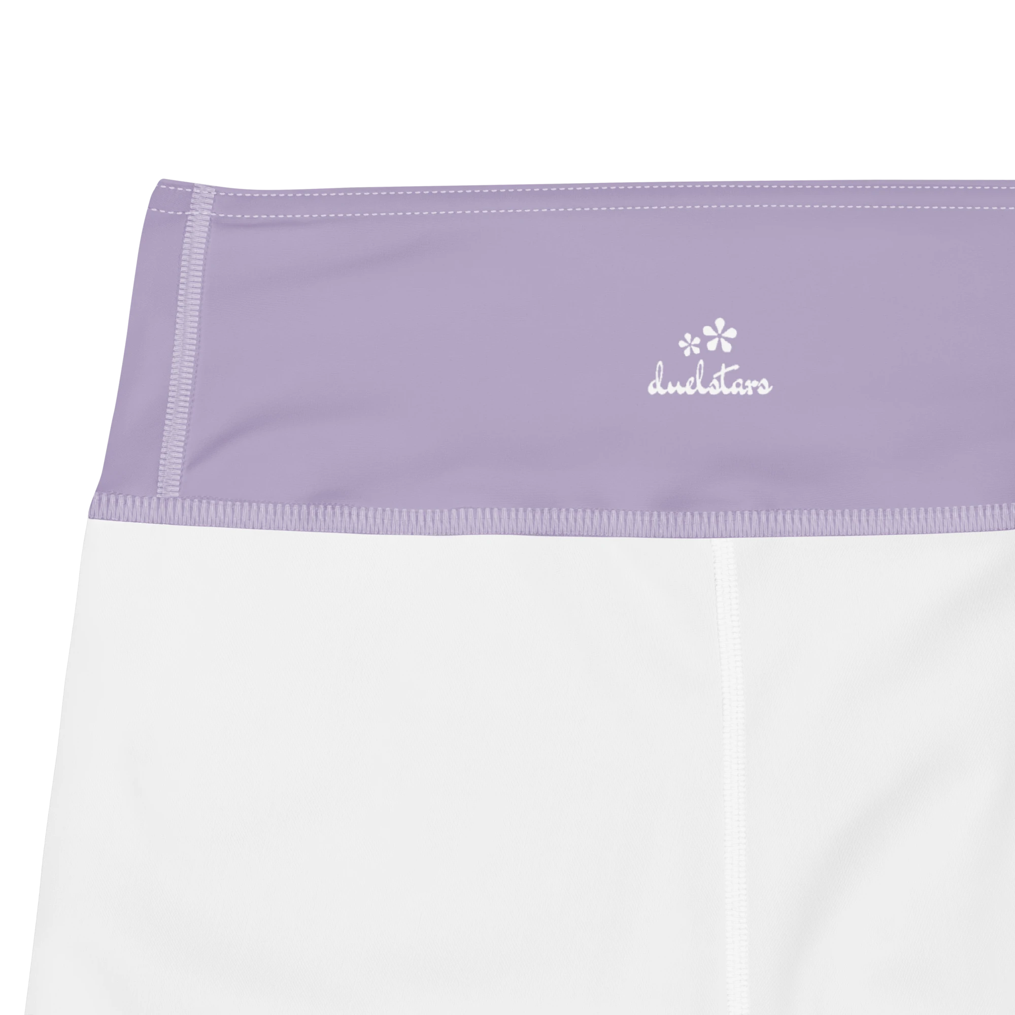 Close-up of the DuelStars label on misty lavender yoga shorts with ivory white floral print 