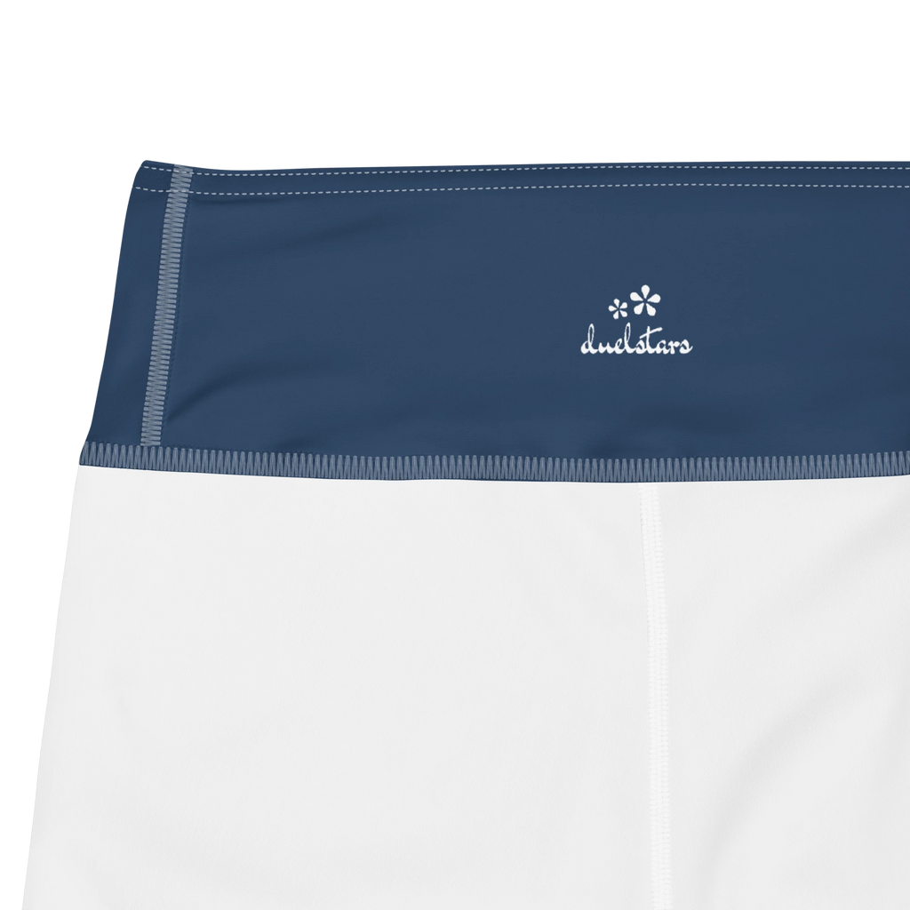 Close-up of the DuelStars label on ocean blue yoga shorts with white floral print 