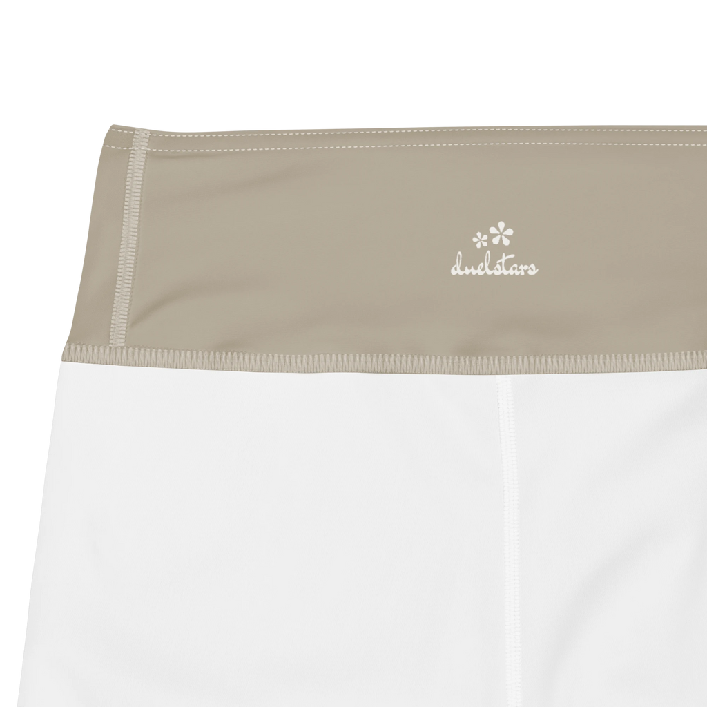 Close-up of the DuelStars label on stone grey yoga shorts with ivory white floral print 