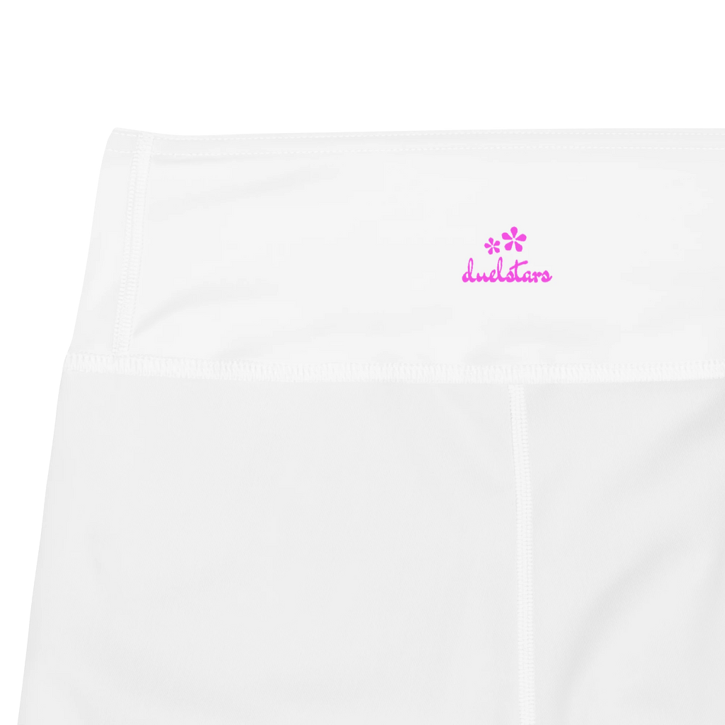 Close-up of the DuelStars label on white yoga shorts wih pink floral print 