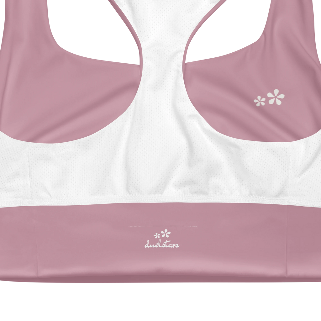 Close-up view of the inside label on the DuelStars Core Femme sports bra in dusty rose, showing the branded DuelStars logo 