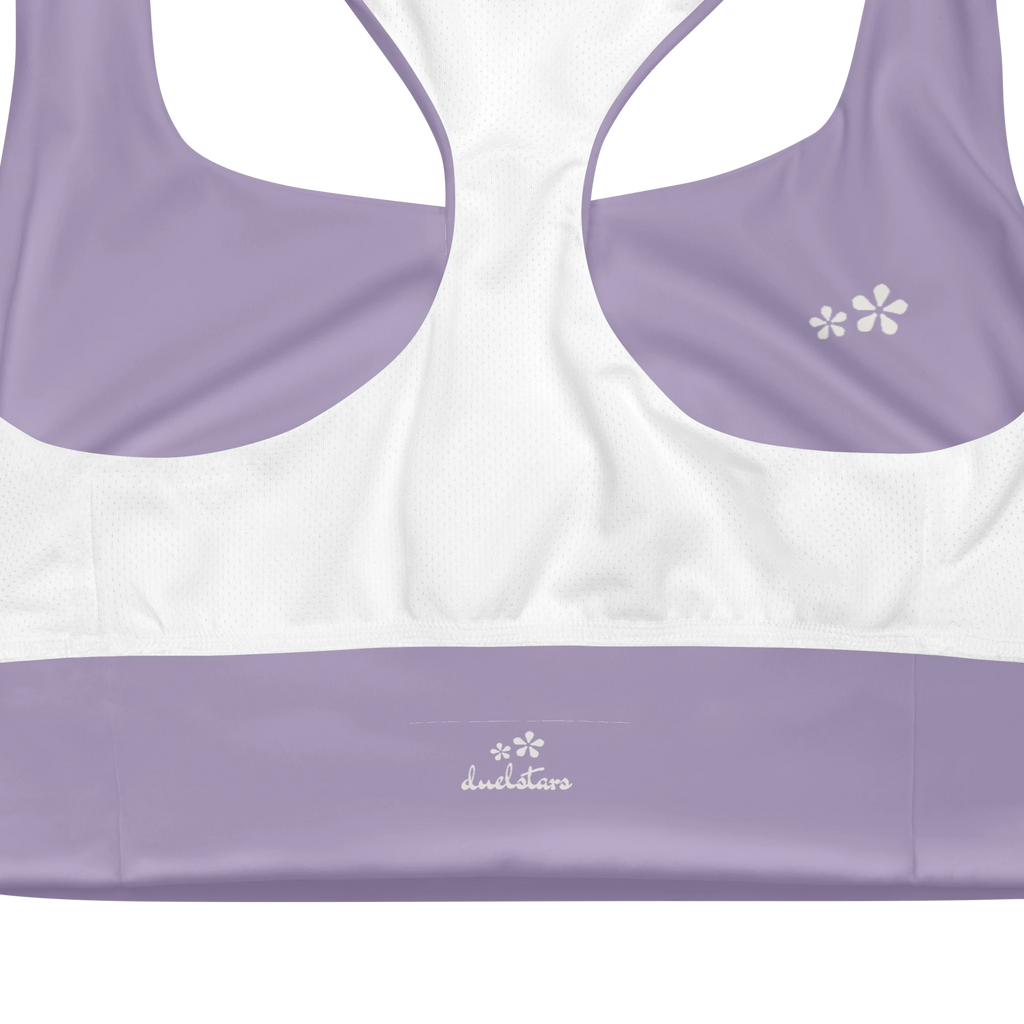 Close-up view of the inside label on the DuelStars Core Femme sports bra in misty lavender, showing the branded DuelStars logo 