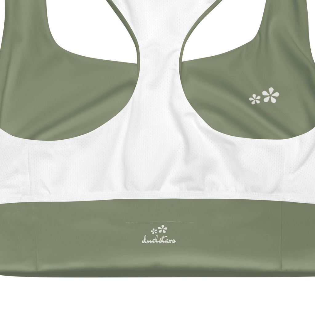 Close-up view of the inside label on the DuelStars Core Femme sports bra in sage green, showing the branded DuelStars logo 