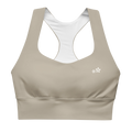 Front view flat lay of the DuelStars Core Femme sports bra in stone grey, featuring the delicate Blossom logo on the chest.