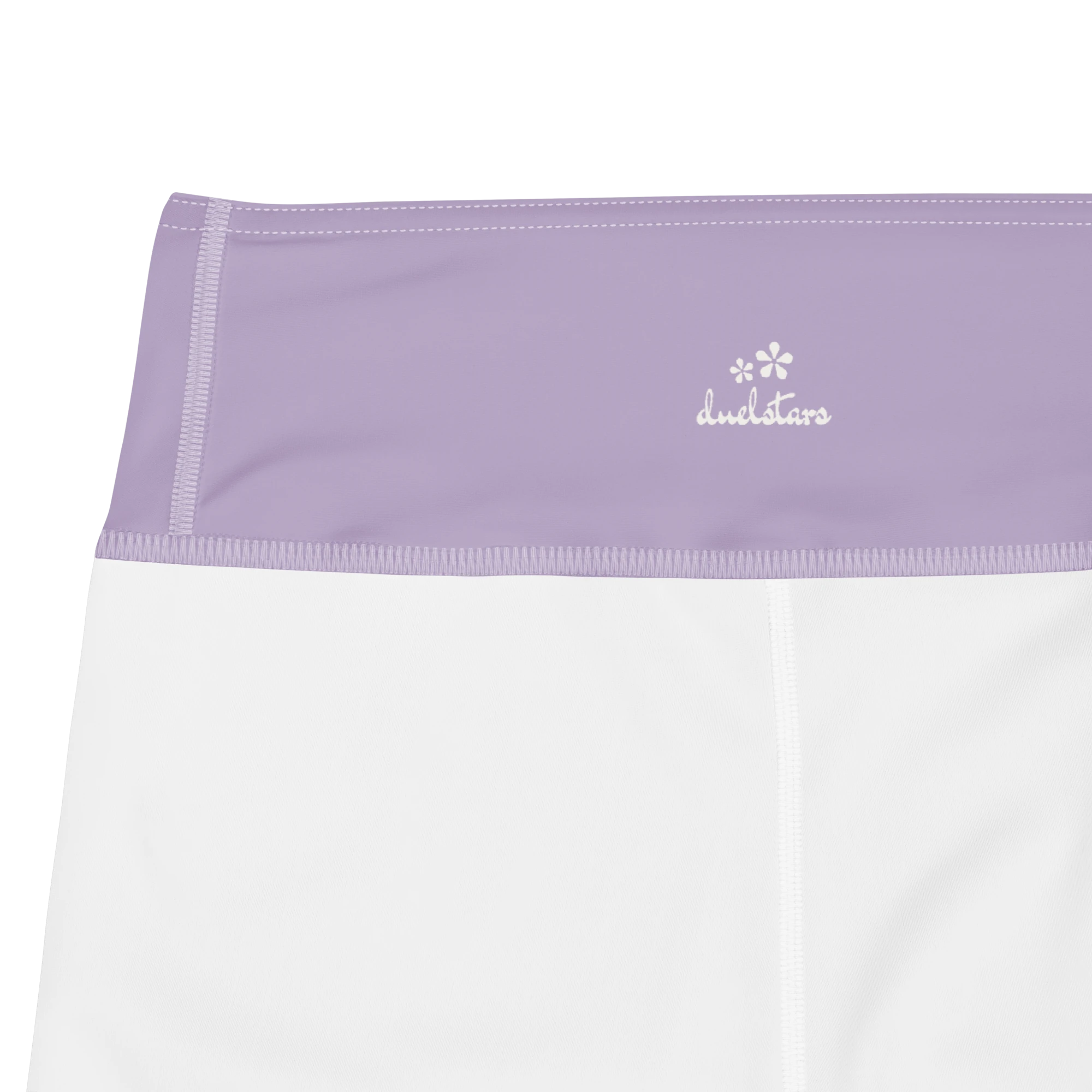Close-up of the DuelStars label on misty lavender yoga leggings with ivory white blossom logo 