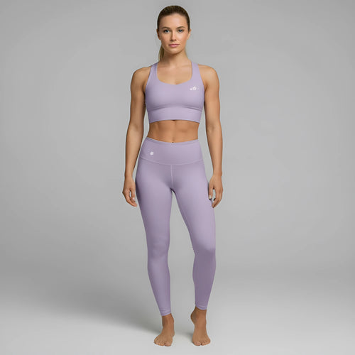 A model showcases the full DuelStars Core Femme sportswear set in misty lavender, featuring the high-waisted leggings and matching sports bra with floral detailing. [cw:mlavender-mist]